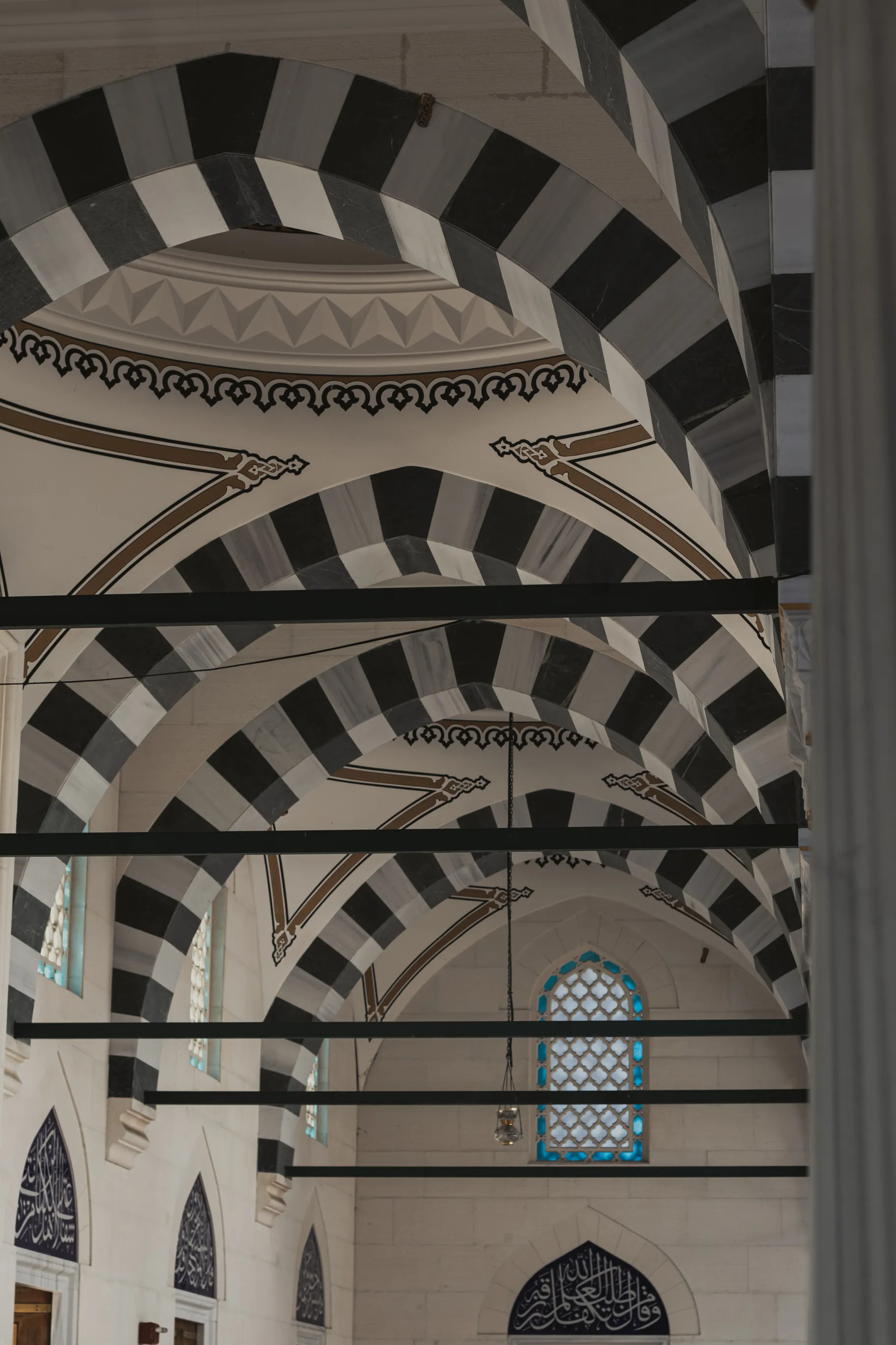Black-and-white striped ablaq arches inside a mosque